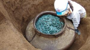 A Ceramic Jar Filled with Thousand of bronze coins Unearthed at the site of a 15th-century Samurai Residents